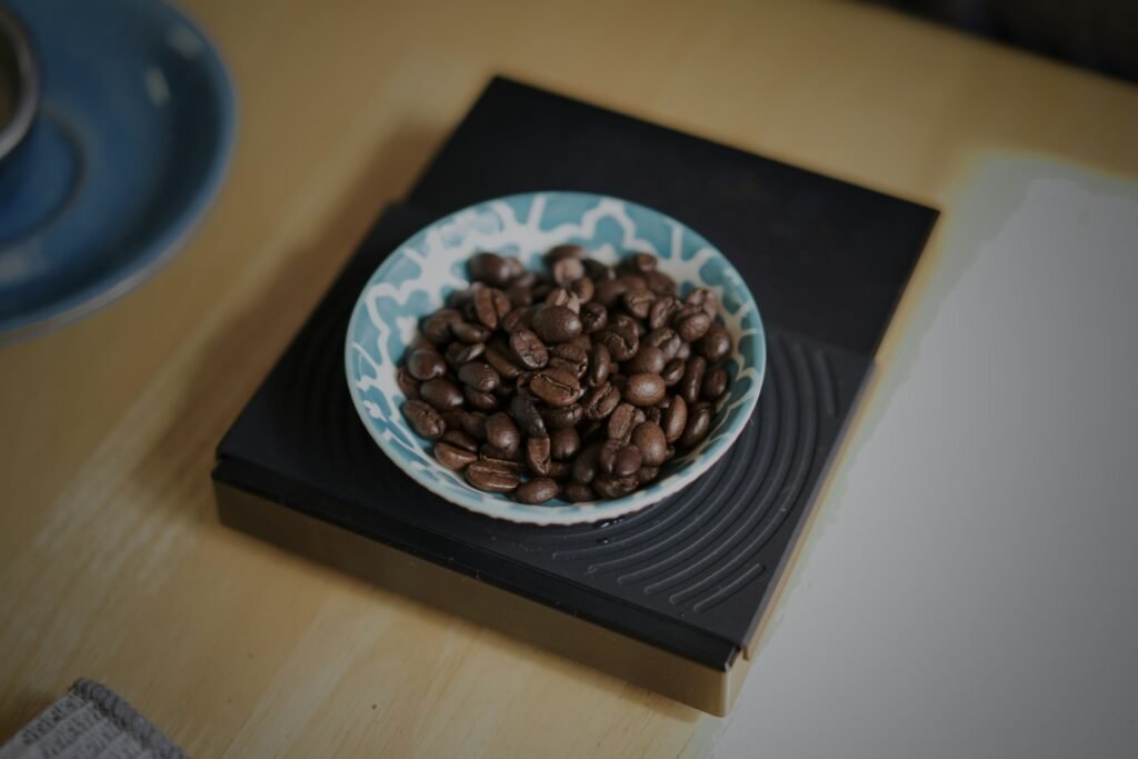 Bowl of coffee beans on a black digital coffee scale
