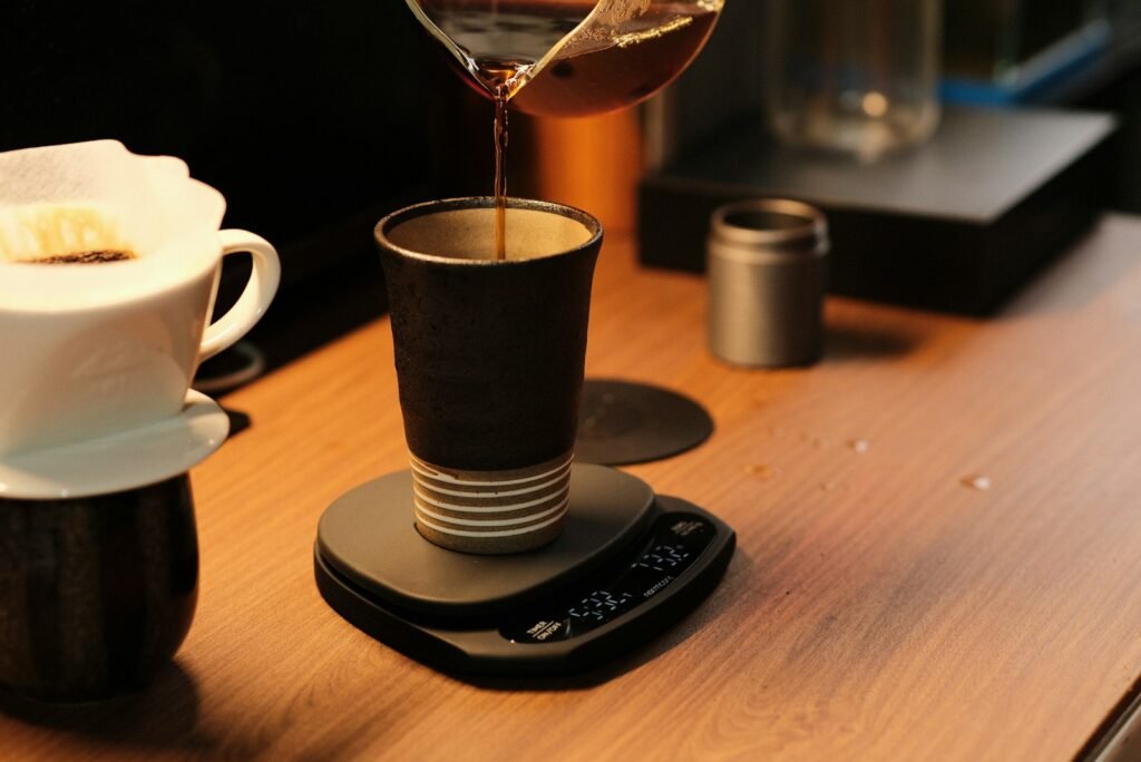Small digital scale weighing coffee as it brews, a common reason people decide they need an espresso scale