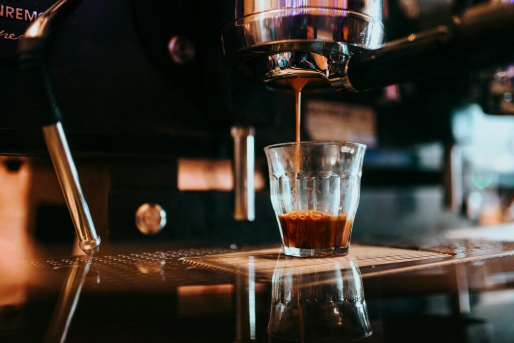 Dark espresso shot pouring into a glass