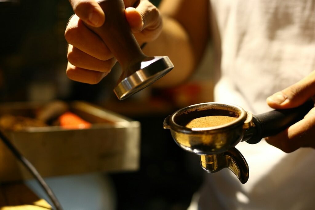Home barista tamping espresso, a step that the right Bambino Plus accessories make easier