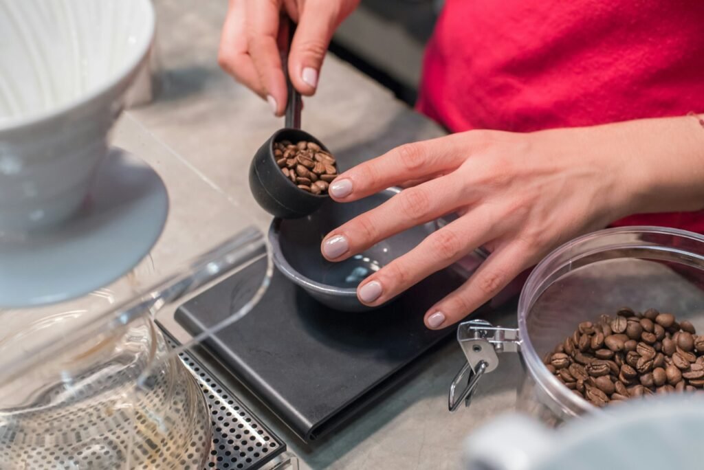 Weighing coffee beans on a digital espresso scale before grinding
